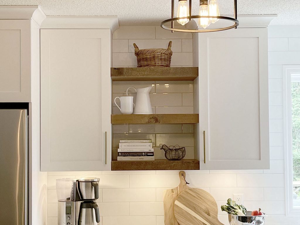 Detail of custom made rustic open shelves with built in under cabinet lighting.